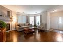 Inviting living room with fireplace, hardwood floors, and large windows at 8338 S Independence Cir # 108, Littleton, CO 80128