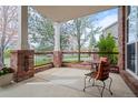 Inviting front porch with brick accents, cozy seating, and a charming neighborhood view at 13804 Quail Ridge Dr, Broomfield, CO 80020