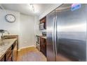 Kitchen featuring stainless steel refrigerator, a sink with granite countertops and stainless steel appliances at 1020 15Th St # 9N, Denver, CO 80202