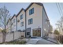 Rear exterior view of the townhome featuring backyard patio with an outdoor seating area and modern siding at 1660 Utica St, Denver, CO 80204