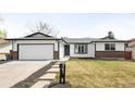 Charming single-story home with a well-maintained lawn, attached garage, and inviting entrance at 558 S Field Ct, Lakewood, CO 80226