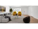 Bright living room featuring hardwood floors, natural light, and stylish contemporary furniture at 558 S Field Ct, Lakewood, CO 80226