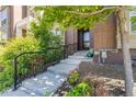 Charming entryway featuring well-maintained landscaping and a stylish black railing at 9158 Martin Luther King Blvd, Denver, CO 80238