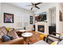 Stylish living room boasts a modern fireplace, hardwood floors, and large TV at 9158 Martin Luther King Blvd, Denver, CO 80238