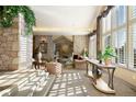 Beautiful living room featuring stone walls, large windows, and an open floor plan at 108 Castle Pines N Dr, Castle Rock, CO 80108