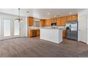 Well-lit kitchen with stainless steel appliances, tile flooring, and access to the backyard at 5798 Biscay St, Denver, CO 80249