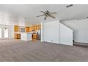 Open-concept living room leading to the kitchen with stainless steel appliances and an island at 5798 Biscay St, Denver, CO 80249
