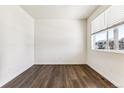 Bright room with hardwood floors, white walls, a large window, and natural light at 27460 E Cedar Pl, Aurora, CO 80018