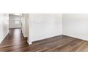 Bright living room with sleek hardwood floors and white trim, showcasing a modern aesthetic at 27460 E Cedar Pl, Aurora, CO 80018