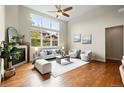 Bright living room with hardwood floors, a fireplace, and a large window offering a view of the yard at 5419 Uinta St, Denver, CO 80238