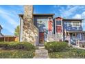 Charming townhouse featuring stone accents, landscaped front yard, and curb appeal at 10008 Quivas St, Thornton, CO 80260