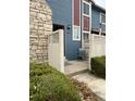 Exterior of charming townhouse with stone chimney, a cozy fenced-in patio area, and a welcoming entrance at 10008 Quivas St, Thornton, CO 80260