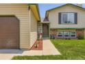 Charming home exterior with a well-manicured lawn, brick accents, and a quaint front entrance at 3762 S Halifax St, Aurora, CO 80013