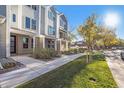 Charming townhouse exterior with landscaped front yard and inviting sidewalk at 888 S Valentia St # 102, Denver, CO 80247