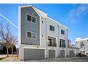 Modern townhome garages with sleek doors and exterior finishes at 888 S Valentia St # 102, Denver, CO 80247