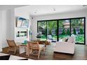 Bright living room with stylish floors, modern furniture, and large windows overlooking the backyard at 4121 S Cherry St, Cherry Hills Village, CO 80113