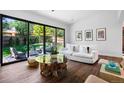 Open-concept living room with backyard view, modern furniture, and stylish decor, filled with natural light at 4121 S Cherry St, Cherry Hills Village, CO 80113