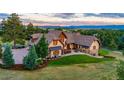 Luxury home with expansive backyard, patio, and mountain views at 83 Castle Pines N Dr, Castle Rock, CO 80108