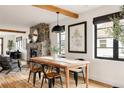 Bright dining area with wooden table and view of stone fireplace and living space at 2951 S Logan St, Englewood, CO 80113