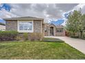 Attractive single-Gathering home with lush green lawn, brick facade and ample natural light at 23808 E Bellewood Dr, Aurora, CO 80016
