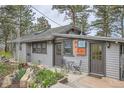 Inviting home exterior with lovely plantings, multiple entry doors, and a cozy seating area at 513 Mt Blue Sky Rd, Golden, CO 80401