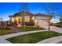 Beautiful home with stone accents, a two-car garage, and a cozy porch under a clear blue sky at 8505 S Tibet Ct, Aurora, CO 80016