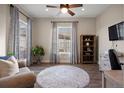 Cozy living room with a patterned rug, a chair, and lots of natural light at 8505 S Tibet Ct, Aurora, CO 80016