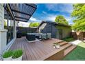 Outdoor living space featuring a large deck, modern pergola, and stylish furniture perfect for entertaining at 2899 Emporia Ct, Denver, CO 80238