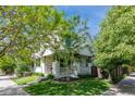 Beautiful home with a inviting front porch and lush landscaping enhancing its curb appeal at 2899 Emporia Ct, Denver, CO 80238