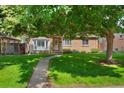 Inviting front exterior of brick home featuring a well-maintained lawn and mature trees at 1080 S Garfield St, Denver, CO 80209