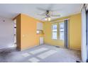 Bright dining room with large windows and ceiling fan at 261 S Newark Cir, Aurora, CO 80012