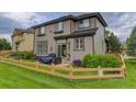 Spacious backyard with a wood fence, green lawn, patio, and lush landscaping for outdoor enjoyment at 3070 Redhaven Way, Highlands Ranch, CO 80126