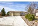 Attractive single-story home featuring a stone facade, an extra-wide driveway and a spacious two car garage at 5480 Craftsman Dr, Parker, CO 80134