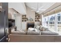 Inviting living room featuring a stone fireplace, vaulted ceilings, and abundant natural light at 8331 S Upham Way # 101, Littleton, CO 80128