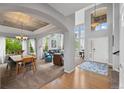 Spacious foyer with a soaring ceiling, hardwood floors, and an open-concept design at 5791 Chisholm Pl, Parker, CO 80134