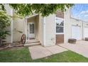 Cozy home entrance featuring white door with sidelight and lush green lawn at 15942 E Rice Pl # B, Aurora, CO 80015