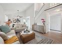 Open living space with white walls, modern decor, and a staircase to the second floor at 15942 E Rice Pl # B, Aurora, CO 80015