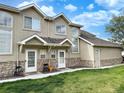 Inviting townhome with stone accents, multiple windows, and a well-kept lawn, creating a charming and attractive exterior at 2247 Coronado Pkwy N #D, Denver, CO 80229