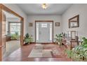 Spacious foyer with hardwood floors, lots of plants, and a stylish rug at 6839 Estes Dr, Arvada, CO 80004