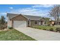 Lovely home with long driveway, two-car garage, and well-maintained lawn at 6839 Estes Dr, Arvada, CO 80004
