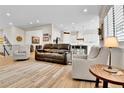 Spacious living area with wood floors, comfortable seating, and an open layout to the kitchen at 1195 Melting Snow Way, Castle Rock, CO 80109