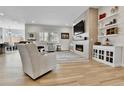Bright and open living room with fireplace, large windows, and neutral decor at 1195 Melting Snow Way, Castle Rock, CO 80109
