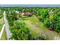 Aerial view of a lot with mature trees and a home on the property at 1961 S Xenia Ct, Denver, CO 80231