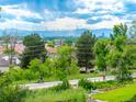 Neighborhood street view of homes with scenic mountain views in the distance at 1961 S Xenia Ct, Denver, CO 80231