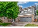 This well-maintained two-story home features a two-car garage and beautiful, lush landscaping at 11716 Fairplay St, Commerce City, CO 80603