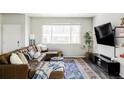 Cozy living room features a plush sectional sofa, large window, and modern decor, creating a comfortable space at 5099 S Robb St, Littleton, CO 80127