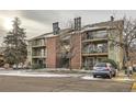 Multi-Gathering residence with balconies, brick features, convenient parking, and well-kept grounds for enhanced curb appeal at 4899 S Dudley St # 17G, Littleton, CO 80123