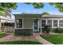 Charming home featuring a welcoming entrance with a teal front door and well-manicured landscaping at 2640 S Marion St # 2646, Denver, CO 80210