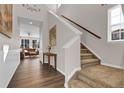 Inviting foyer with hardwood floors, staircase, and view into the living area, creating a warm, welcoming atmosphere at 3266 Riverwood Way, Castle Rock, CO 80109