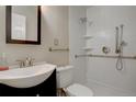 Bright bathroom with a sleek vanity, modern fixtures, and a accessible walk-in shower at 731 Uvalda St, Aurora, CO 80011